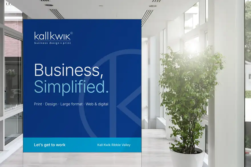 A large Kall Kwik feature wall graphic in a bright office atrium